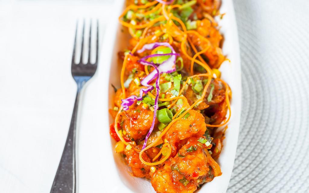 Gobi Manchurian (Dry) · Crispy cauliflower tossed with onion, bell pepper, green onion and tangy tomato sauce