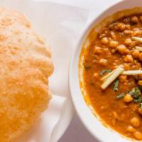 Chana Bhatura · Garbanzo beans cooked in the traditional Punjabi street food style & served with puffed leav...