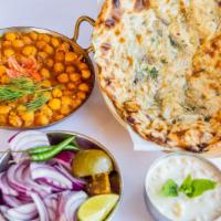 Amritsari Kulcha Chole · Flaky traditional layered flat bread served with spiced chickpeas.