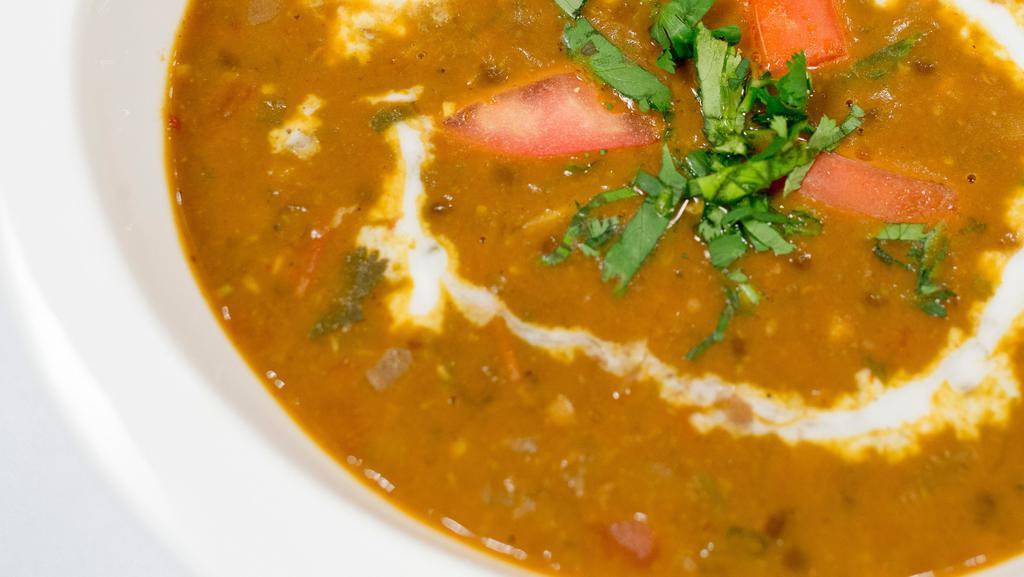 Dal Bukhara · A harmonious slow cooked mélange of black lentil, tomatoes, ginger, garlic and house spices.