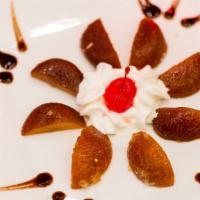 Gulab Jamun · Fried thickened milk dumplings soaked in rose-flavored sugar syrup