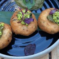 Edamame Vada · Vegetarian. Black lentil ‘dumplings’,
mint edamame chutney, cilantro