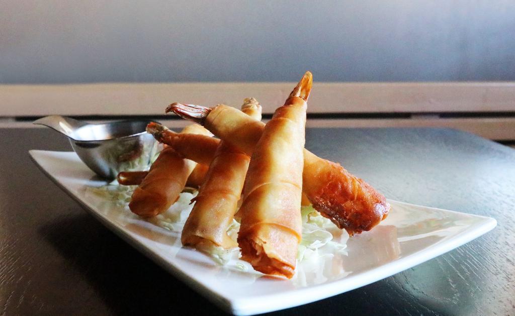 Fried Shrimps · Tail-on shrimp wrapped in a wonton and deep fried until crispy golden brown accompanied with a chili sauce