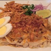 Nan Pya Dok · House special noodle; flat wide wheat noodles, diced chicken in a mild coconut curry sauce, ...