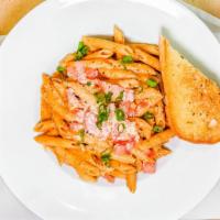 Cajun Penne Pasta · A choice of chicken or jumbo shrimp smothered in alfredo sauce with a hint of Cajun spice. T...