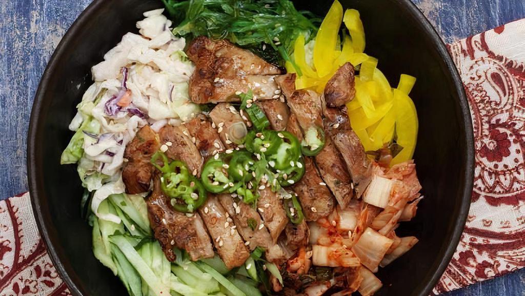 Grilled Chicken Kimchee Rice Bowl · Served with steamed rice kimchee seaweed salad yellow radish cucumber and coleslaw. steam rice kimchee daikon seaweed and wasabi apple coleslaw.