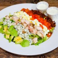 Chicken Cobb Salad · Romaine lettuce topped with chicken breast, applewood smoked bacon, blue cheese crumbles, ha...