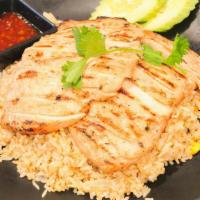 Grilled Chicken Over Fried Rice · Grilled chicken breast over fried rice, eggs, yellow & green onions, tomatoes. Served with o...