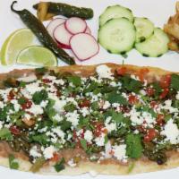 Huarache · Huarache is a popular Mexican dish consisting of corn masa dough with smashed, it is given a...