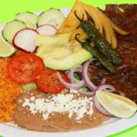Carne Asada · Authentic carne asada. marinated steak grilled to perfection served with rice beans salad gr...