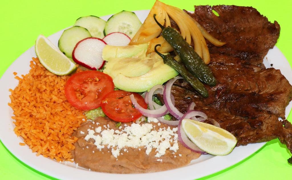 Carne Asada · Authentic carne asada. marinated steak grilled to perfection served with rice beans salad grilled onion and a side of tortillas.