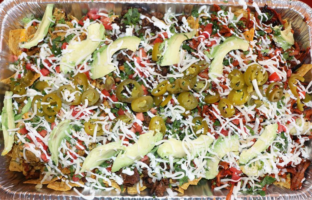 Mega Nachos (Tres Carnes) · Delicious Nachos for 6-8 people. Depending how hungry you are. LoL - Crispy organic tortilla chips topped with refried beans, nacho cheese, sour cream, pico de gallo, avocado, and jalapeños. We separated the three meats. Juicy tender Asada (Beef), Pollo (Grilled Chicken), and Pastor (Marinated Pork). Topped with mozzarella cheese.