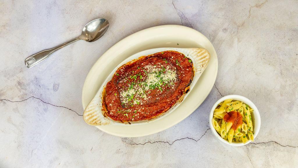 Eggplant Parmigiana · Vegan without the Mozz. Cheese and the parmesan cheese on top. Breaded fried eggplant in our classic homemade marinara sauce, with melted mozzarella cheese.