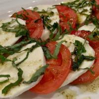 Caprese Salad · Fresh Mozzarella, tomato, and basil topped with extra virgin olive oil.