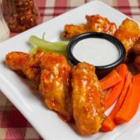 Sweet Chili Wings · Deep-fried wings tossed in sweet chili sauce, served with a side of ranch dressing.