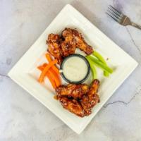 BBQ Wings · Deep-fried wings tossed in BBQ sauce, served with a side of ranch dressing.
