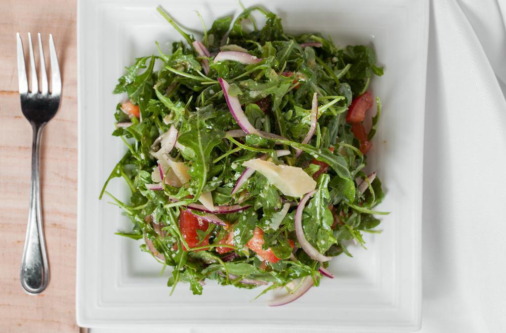 Arugula Salad · Healthy. Arugula, fresh diced tomatoes, red onions, shaved Parmesan, lemon vinaigrette.