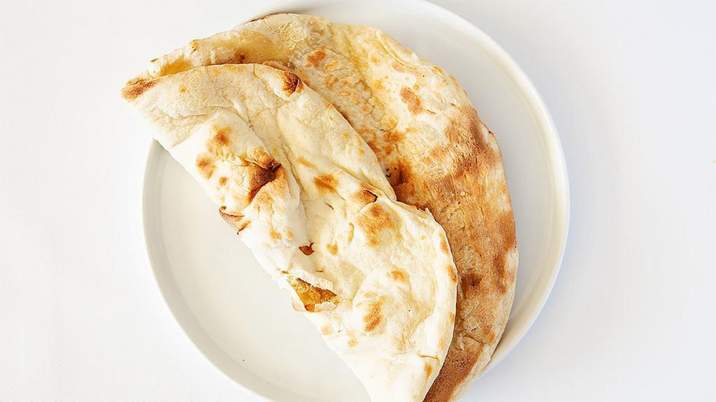 Plain Naan · very famous unleavened white bread baked in clay oven.A real punjabi touch