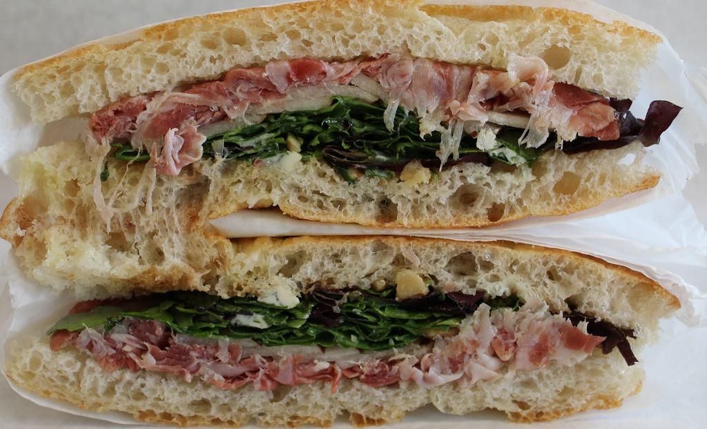 Prosciutto Sandwich · pear, blue cheese, pickled onions, walnut, balsamic, greens