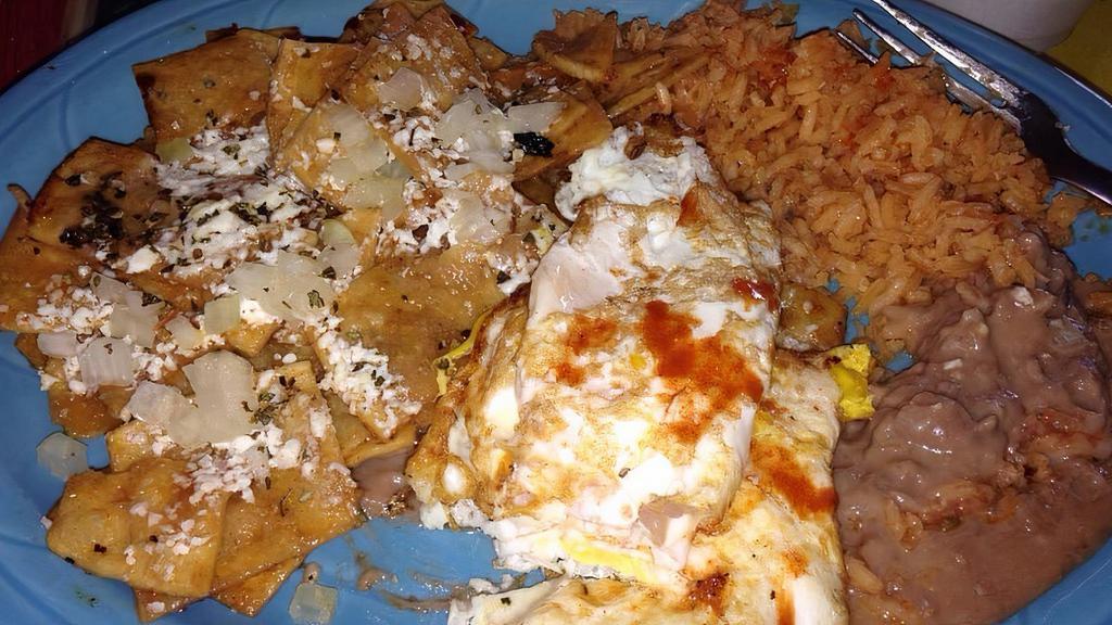 Chilaquiles · Eggs scrambled with crisp corn tortillas, red or green sauce topped with onion, oregano and cheese. Served with refried beans and rice.
