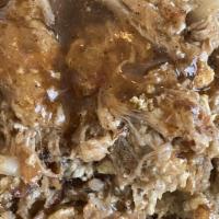 Machaca De Carnitas · Slow roasted pork scrambled with eggs, onion and tomato served with refried beans, rice and ...