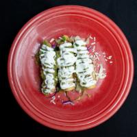 Mini Flautas (3) · Corn tortilla stuffed with chicken and deep fried. Topped with guacamole, sour cream and che...