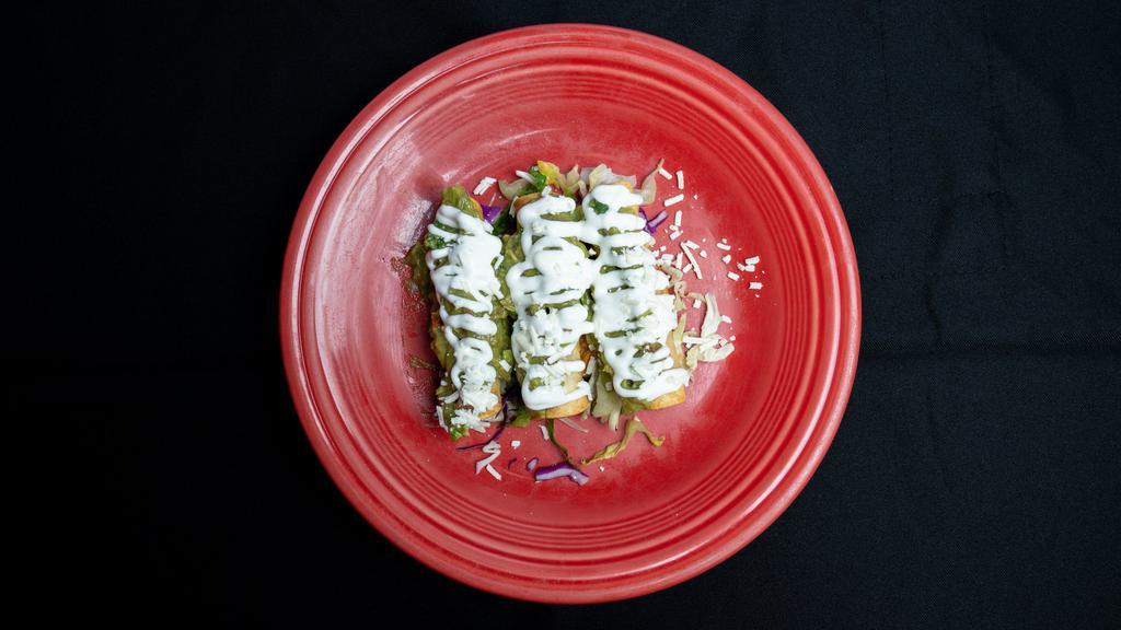 Mini Flautas (3) · Corn tortilla stuffed with chicken and deep fried. Topped with guacamole, sour cream and cheese.