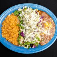 Enchiladas Rancheras · Two corn tortillas dipped in red sauce and grilled with choice of ground beef, chicken or po...