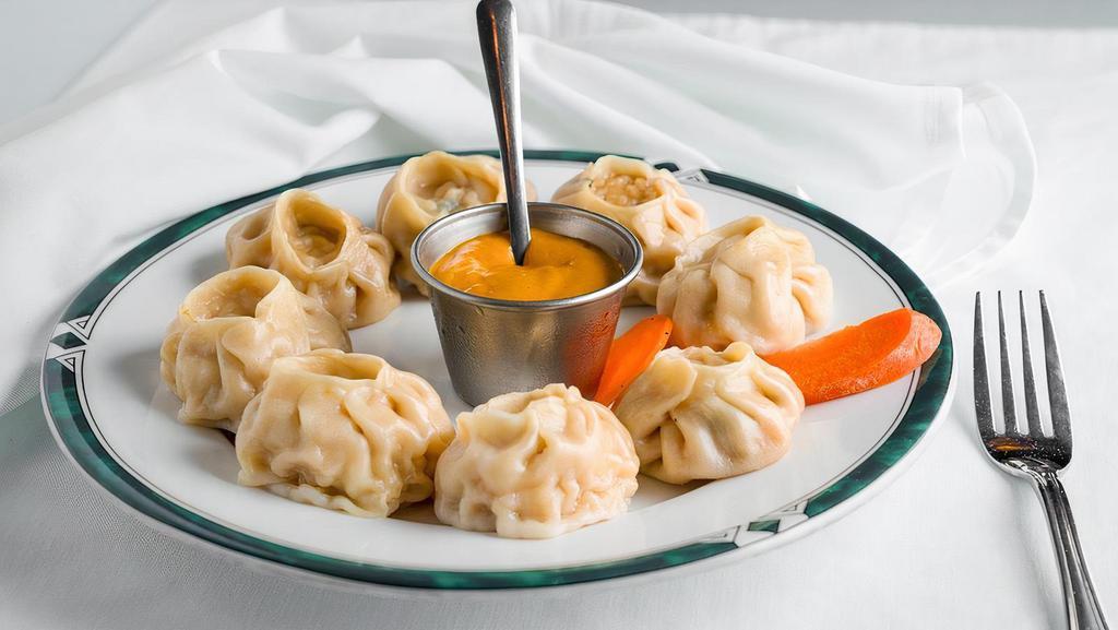 Vegetable Momo (8) · Steamed dumplings filled with minced cabbage, spinach, cashews nuts, paneer, onion, cilantro, green onion and spices. Served with Himalayan sauce.