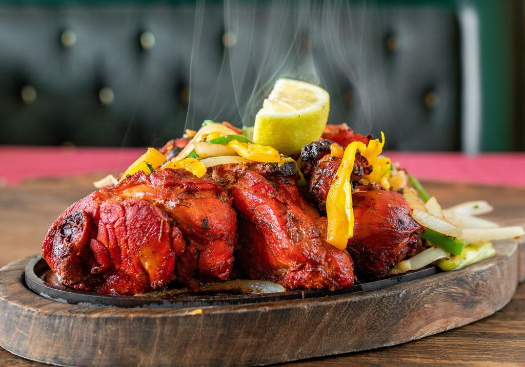 Whole Tandoori Chicken (4 pcs) · 2 legs and 2 breasts. Whole chicken marinated in yogurt with special herbs and spices.