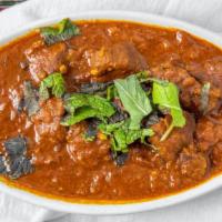 Lamb Curry · Lamb Chunks, Cooked With Fresh Ground Spices, Onions And Tomato Gravy.