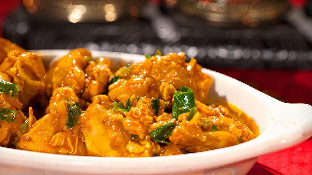 Chicken Curry · Gluten-free. Boneless chicken cooked with garlic, onion, ginger, tomatoes and curry spices. Served mild, medium or hot with a side of basmati rice, brown rice or naan.