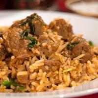 Lamb Biryani · Lamb Pieces Cooked With Curry Seasoned Basmati Rice, Cashew Nuts, Raisins And Peas.