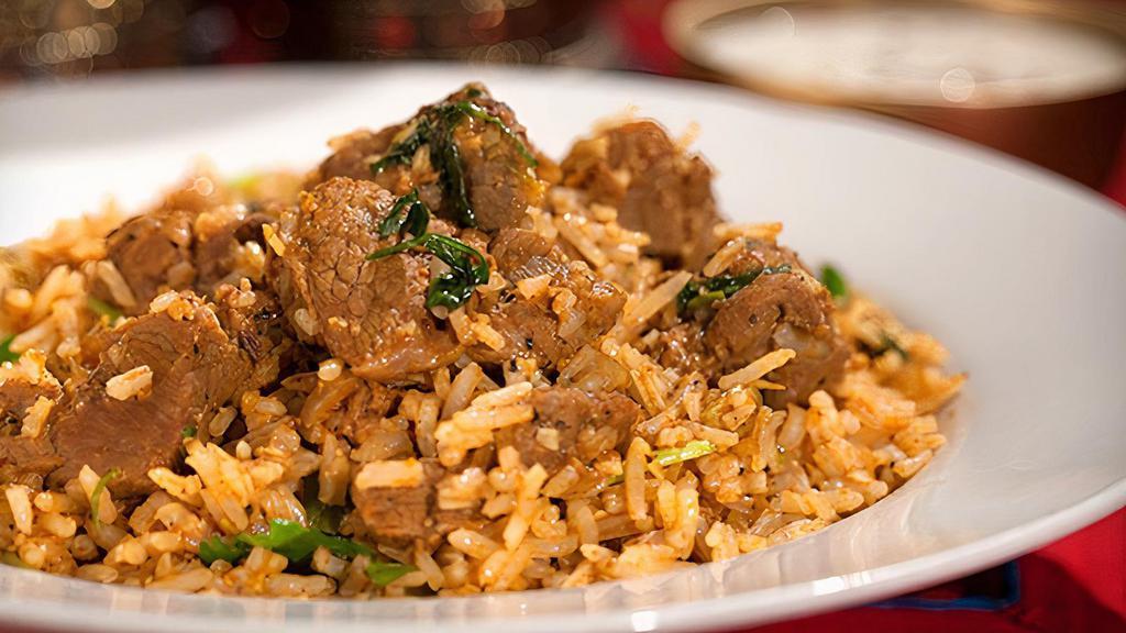 Goat Dum Biryani (Talapakattu) · Fresh goat meat with bone marinated with herbs and spices, cooked with basmati rice.