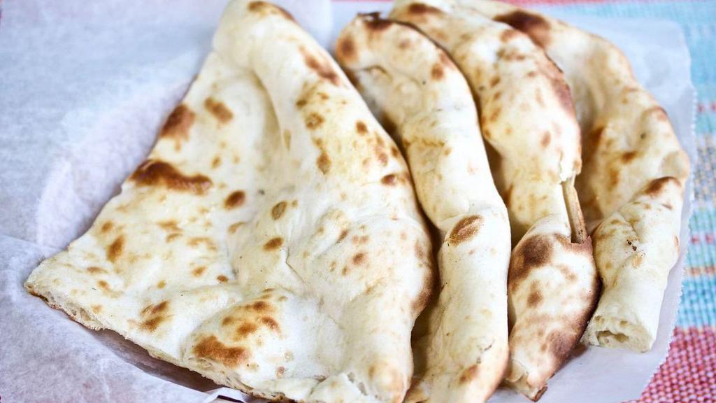 Plain Naan (2 pcs) · Indian bread made with all-purpose flour baked in clay oven.