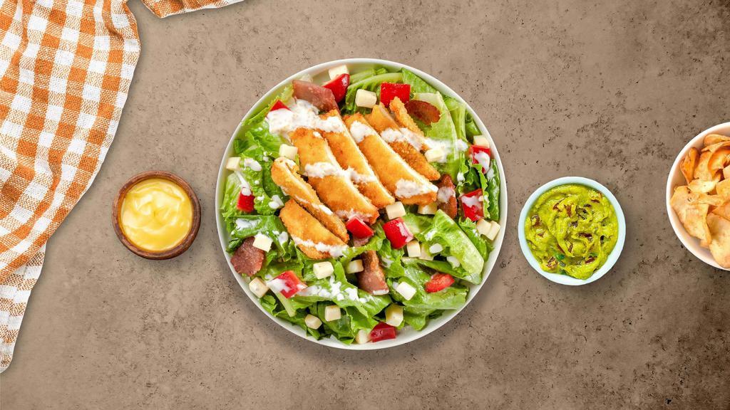 Golden Chicken Salad · Iceberg lettuce, crispy chicken tenders, red onions, fresh Roma tomatoes, cheddar cheese, mozzarella cheese, seasoned croutons, bell peppers, and black olives tossed with your choice of dressing.