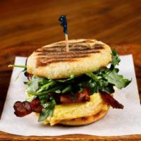 The Grove Breakfast Sandwich · soft scrambled eggs, American heritage ham or applewood smoked bacon, aged sharp cheddar, wi...