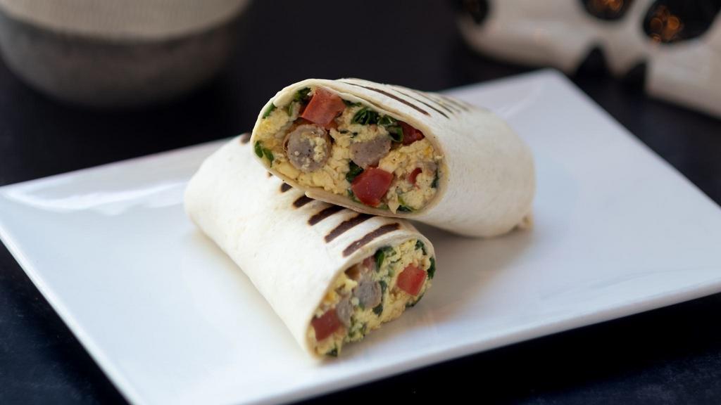 Breakfast Burrito · Two eggs, cheese, tomatoes, spinach and sausage in a wrap with a side of our homemade chipotle sauce.