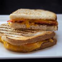 Grilled Cheese · Your choice of bread and two slices of cheese with tomato and bacon.