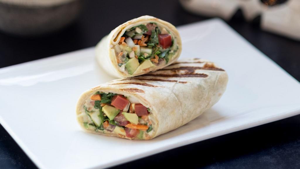 Hummus Wrap · Hummus, tomato, cucumber, red onion, mushrooms, carrots, spinach and avocado in a wrap.