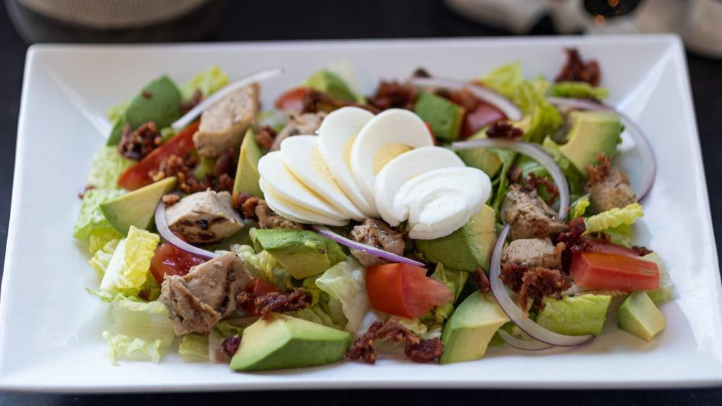 Chicken Cobb Salad · Romaine lettuce, grilled chicken, bacon, avocado, tomatoes, red onion, hard-boiled eggs, and choice of dressing.