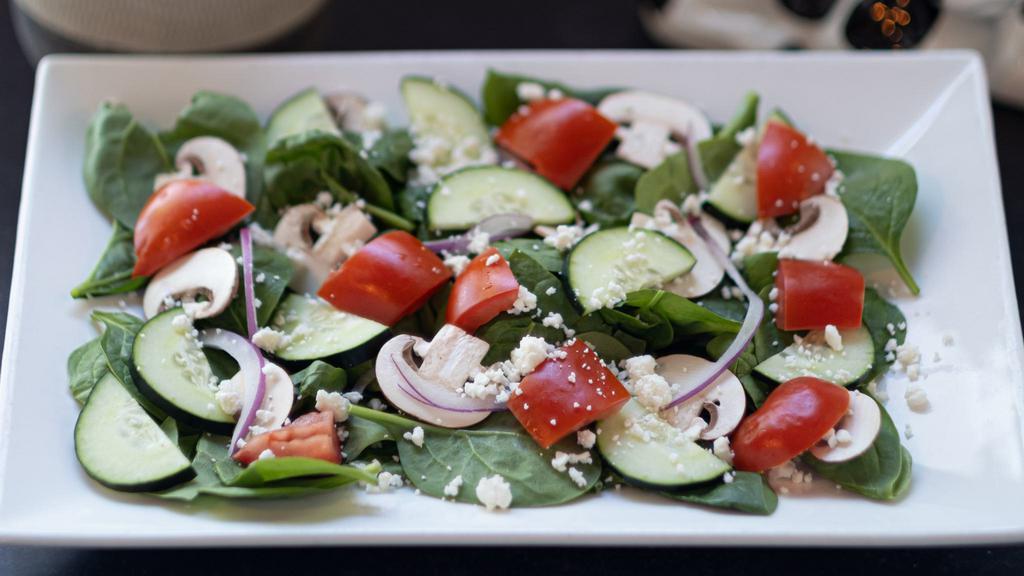 Spinach Salad · Spinach, red onion, mushrooms, cucumbers, tomatoes, feta cheese, and balsamic vinaigrette.