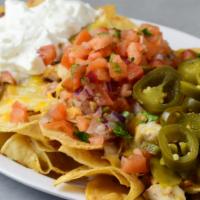 Aladrienne Chicken Nachos · Choice of black eyed peas or red beans, home fried tortilla chips, cheese, sour cream, jalap...