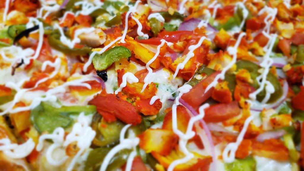 Tandoori Chicken Pizza · Creamy garlic sauce, cheese, bell peppers, red onions, diced tomatoes, tandoori chicken, ginger, pickled jalapeño peppers, fresh cilantro and topped with mayo.