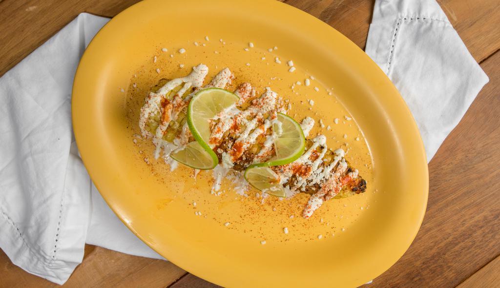 Elote - Grilled Corn on the Cob · Grilled corn on the cob topped with a chili-spiked cream sauce and Mexican cotija cheese.