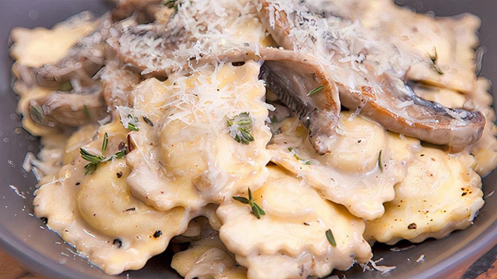 Truffle Mushroom Ravioli · Portobello mushroom, ricotta cheese, parmesan cheese, toasted almonds and truffle mushroom paste cream sauce