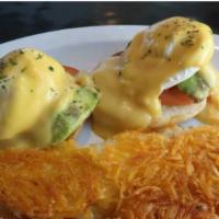 Veggie Benedict · Poached eggs, avocado, tomato and creamy hollandaise sauce on a grilled english muffin.