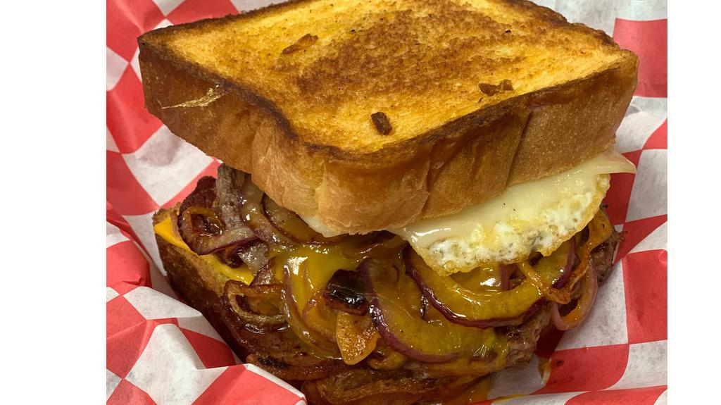 Lumpy’s Stubb · 1/3lb burger patty on grilled Texas Toast, topped with melted Swiss and American cheese, crisp bacon, over hard egg and grilled onions.