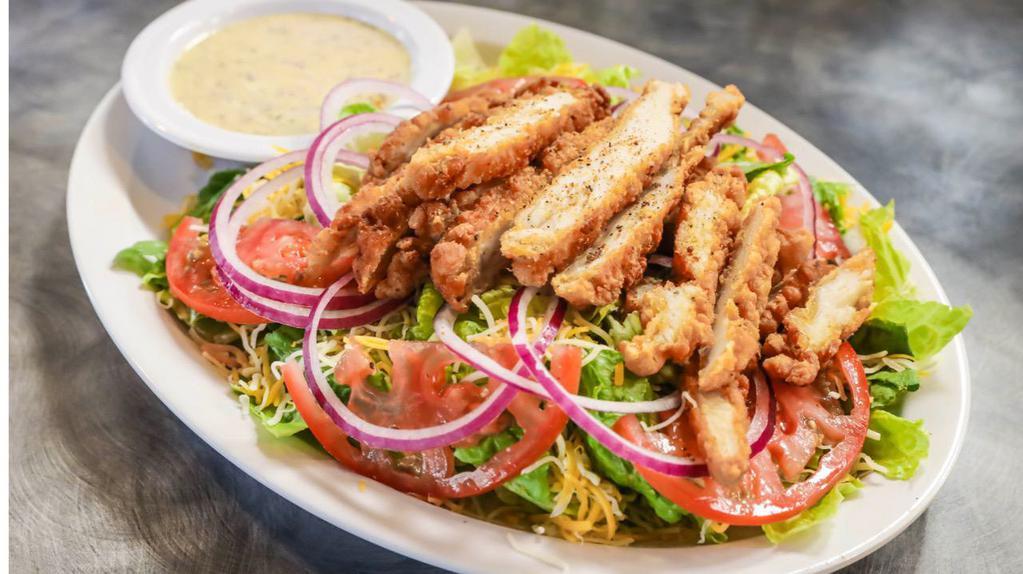 Fried Chicken Salad · Fresh romaine lettuce topped with crispy fried chicken strips, onions, tomatoes and shredded cheddar cheese, served with honey poppyseed dressing (grilled chicken upon request).