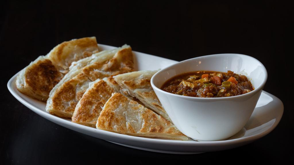 Palata · A flaky layered flatbread bread with vegetarian or coconut chicken curry or lamb curry.